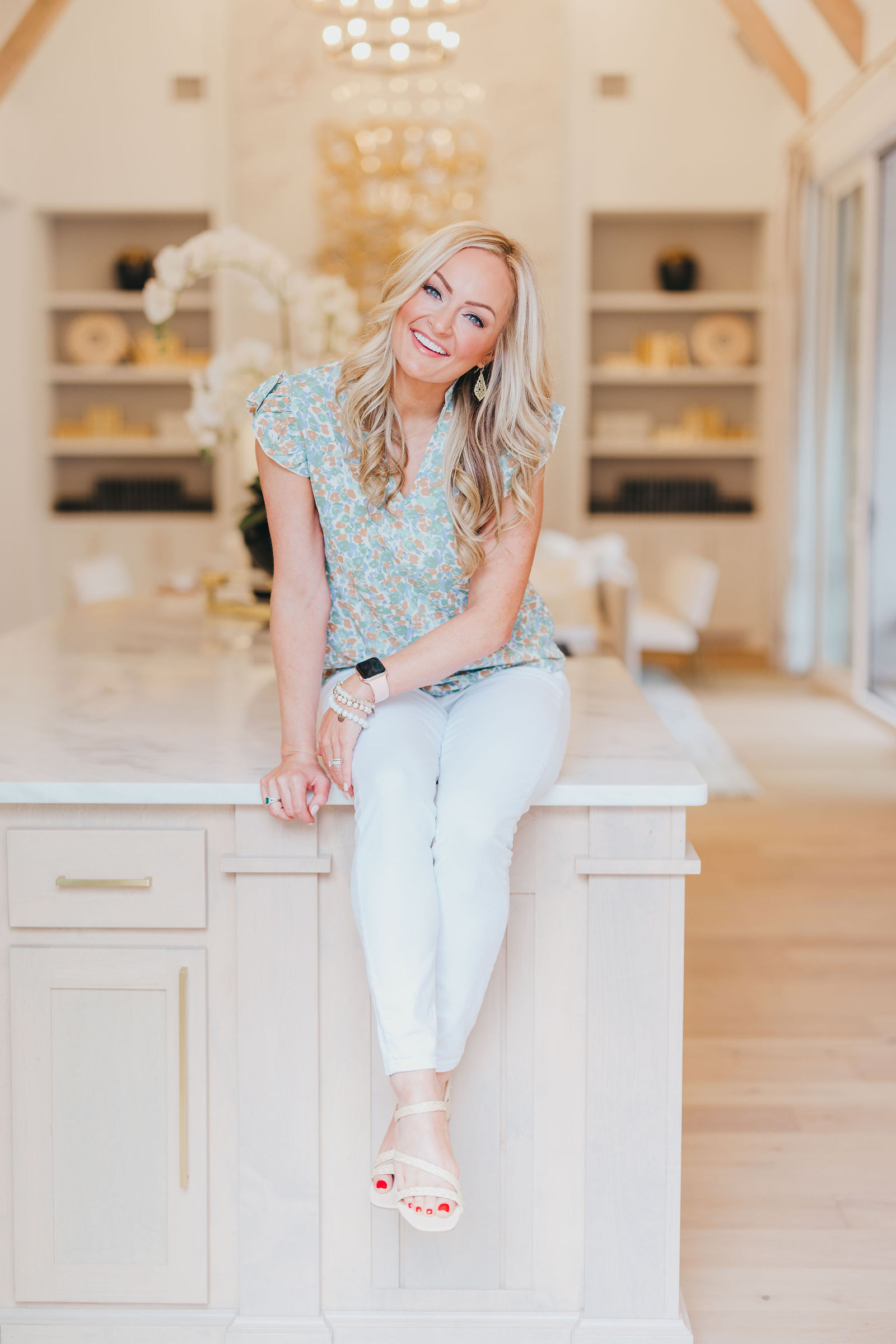 Kaitlin Lovern, founder and lead REALTOR of the Kaitlin Lovern Real Estate Team, in a Frisco, TX luxury kitchen