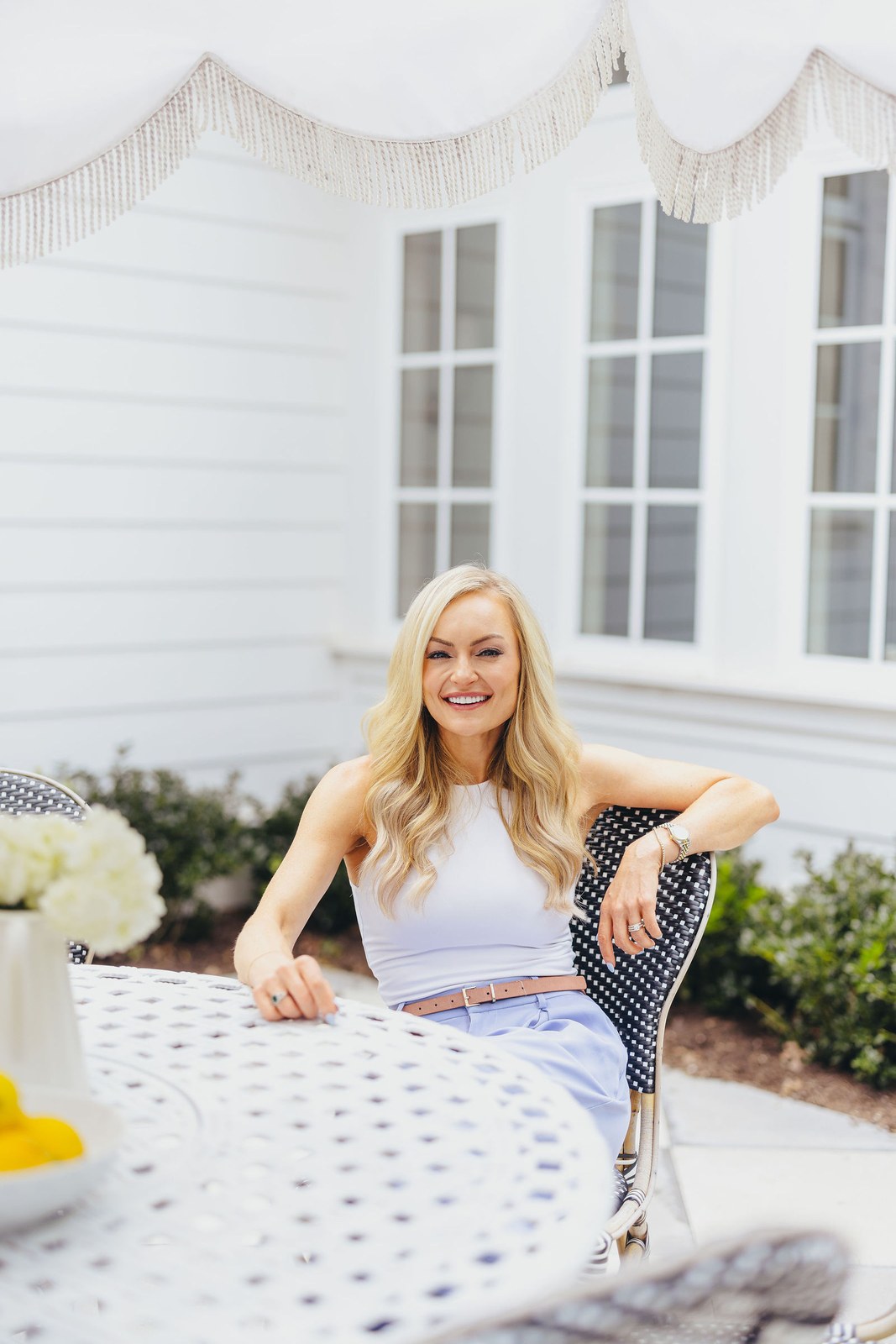 Kaitlin Lovern, North Dallas REALTOR, in a white top and blue skirt, serving Frisco, TX