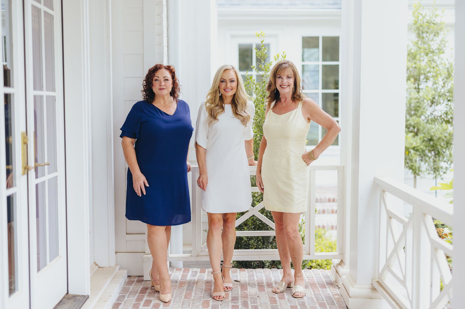Kaitlin Lovern and her real estate team at the entrance of a North Dallas home